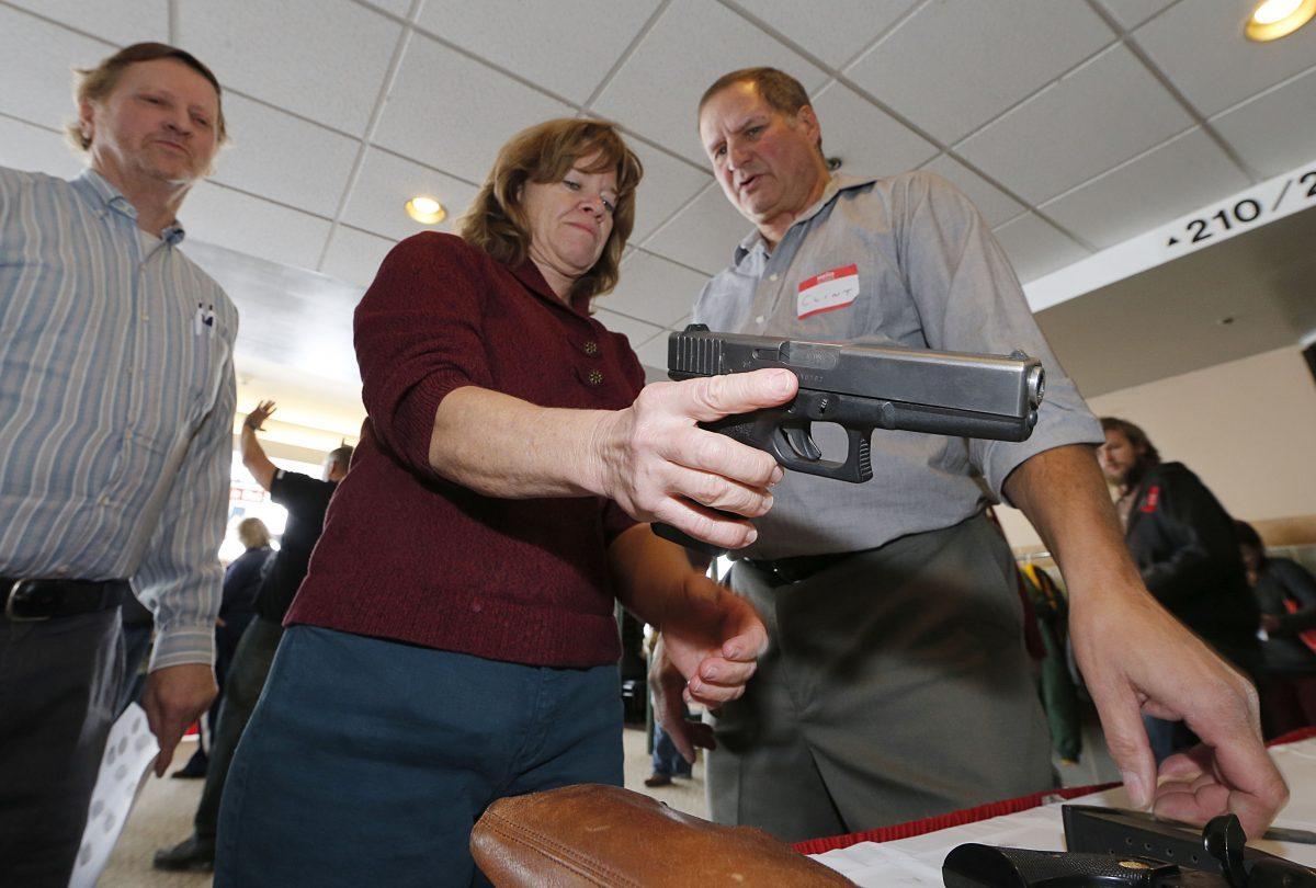 A Utah teacher is shown how to handle a handgun by instructor Clint Simon (R) at a concealed-weapons training class for 200 Utah teachers in West Valley City on Dec. 27, 2012. (George Frey/Getty Images)