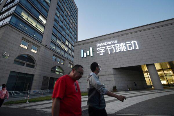 People walk past the headquarters of ByteDance, the parent company of video sharing app TikTok, in Beijing on Sept. 16, 2020. (Greg Baker/AFP via Getty Images)