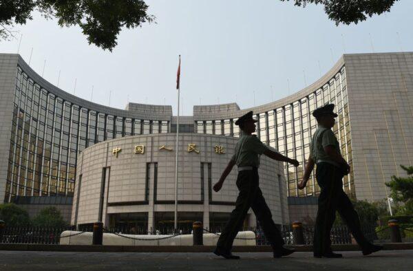 Paramilitary policemen patrol in front of the People's Bank of China, the central bank of China, in Beijing on Jul. 8, 2015. (Greg Baker/AFP via Getty Images)