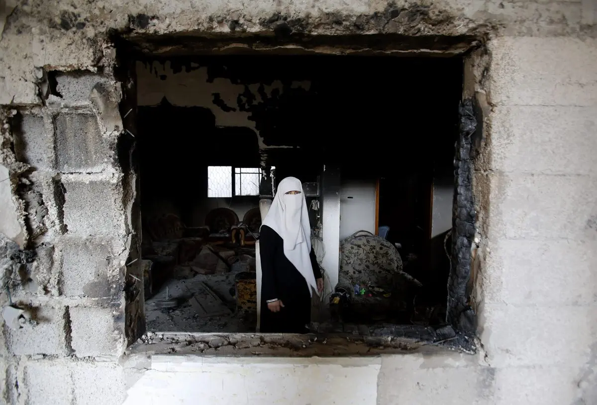  A Palestinian woman stands in the rubble of her home, destroyed during the 2014 Gaza War, in Gaza City’s Shijaiyah neighborhood, on Aug. 11, 2014. Under Hamas control, Gaza is ruled under Muslim canonical law, known as Sharia. Sharia prescribes stoning as a form of capital punishment for certain offenses. (Hatem Moussa/AP Photo)