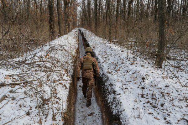 A Ukrainian service member walks along fighting positions on the contact line with Russian-backed separatist rebels near the town of Avdiivka in the Donetsk region of Ukraine on Feb. 13, 2021. (Oleksandr Klymenko/Reuters)