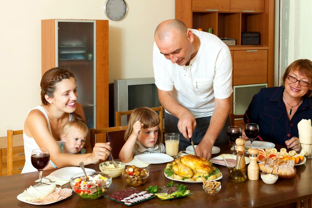 Sit-down family meals together are often a key time for children to learn a wide range of words, concepts, and stories. (BearFotos/Shutterstock)