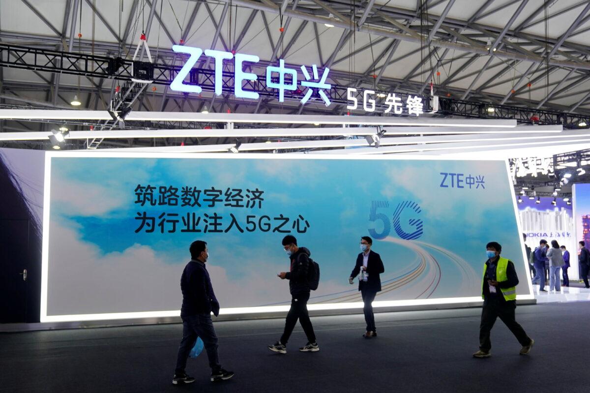 People walk past a ZTE Corp. booth at the Mobile World Congress (MWC) in Shanghai on Feb. 23, 2021. (Aly Song/Reuters)
