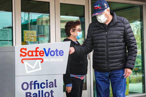  Residents drop mail-in ballots in a ballot box outside of the Tippecanoe branch library in Milwaukee, Wis., on Oct. 20, 2020. (Scott Olson/Getty Images)