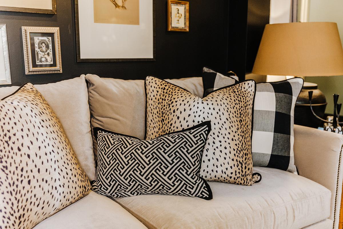 Pillows in black, white and brown featuring organic and geometric patterns add texture to a light tan velvet sofa. (Handout/TNS)