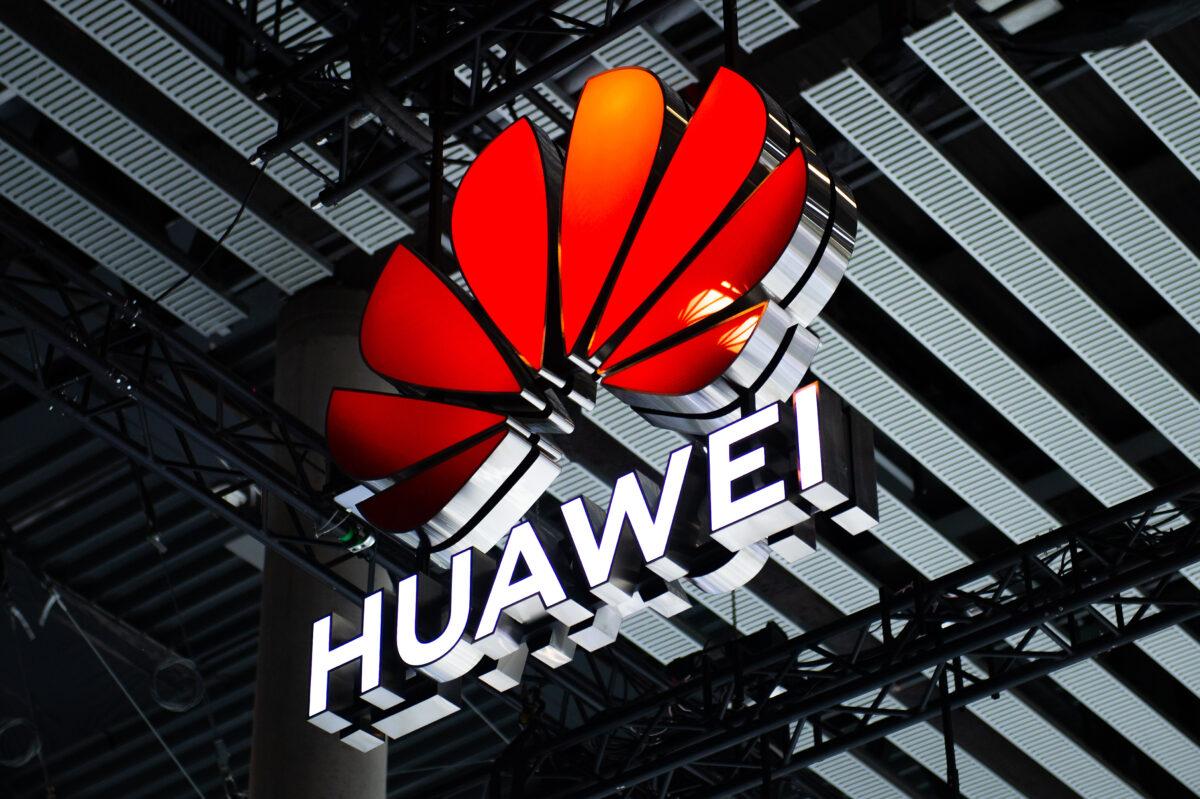 A logo sits illuminated outside the Huawei booth at the SK telecom booth on day one of the GSMA Mobile World Congress in Barcelona on Feb. 28, 2022. (David Ramos/Getty Images)