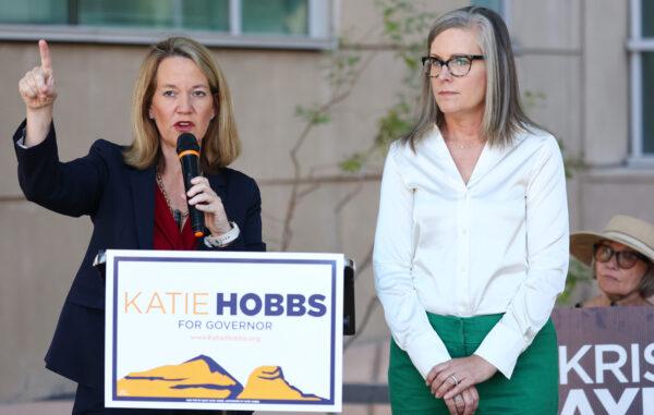 Arizona Secretary of State and Democratic gubernatorial candidate Katie Hobbs (R) looks on as Kris Mayes (L), Democratic candidate for Arizona attorney general, speaks at a press conference in Tucson, Ariz., on Oct. 7, 2022. (Mario Tama/Getty Images)