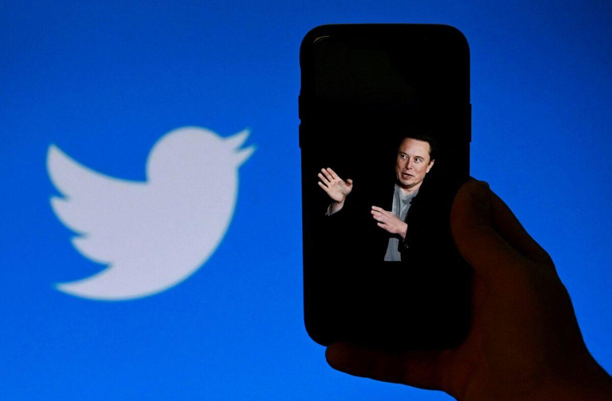A phone screen displays a photo of Elon Musk with the Twitter logo shown in the background in Washington on Oct. 4, 2022. (Olivier Douliery/AFP via Getty Images)