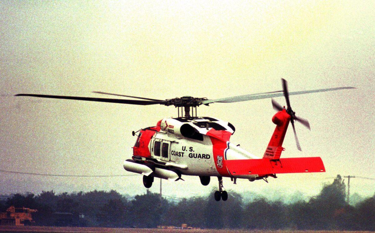 A U.S. Coast Guard helicopter leaves the Coast Guard Air Station on Cape Cod on Oct. 31, 1999, for the debris field discovered 45 miles (70 km) south east of the island Nantucket. (John Mottern/AFP via Getty Images)
