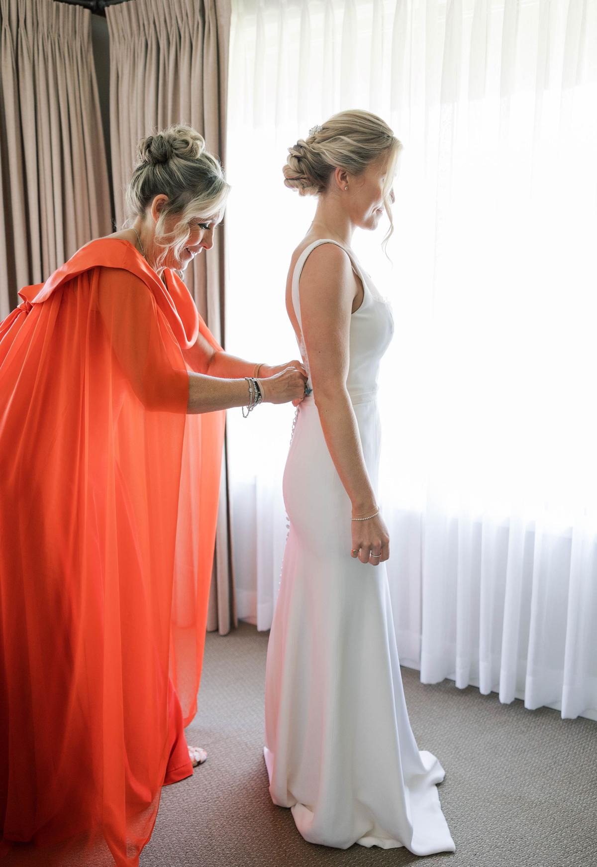  Ms. Wardlaw helped Ms. Fumia with her dress. (Courtesy of <a href="https://www.facebook.com/jessicarice.co">Jessica Rice Photography</a>)