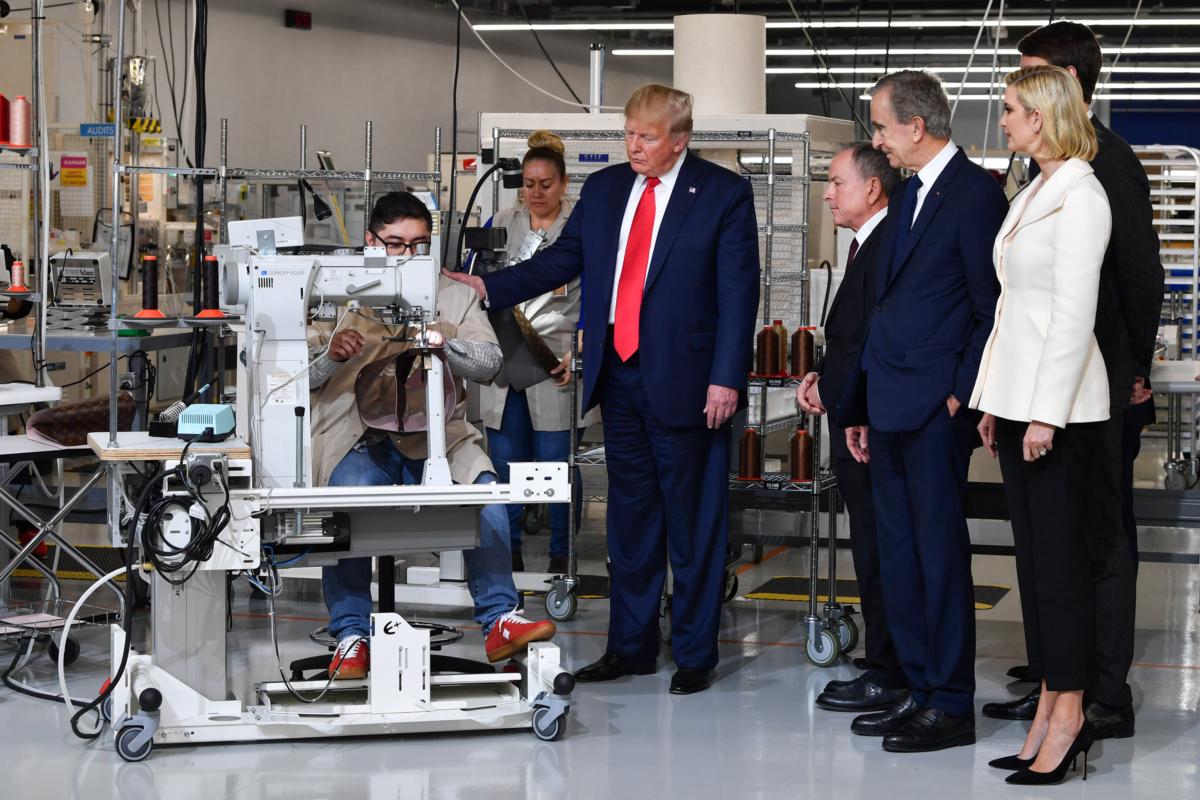 Then-President Donald Trump watches a worker's demonstration during a visit to the Louis Vuitton factory in Alvarado, Texas, on Oct. 17, 2019. (Nicholas Kamm/AFP via Getty Images)