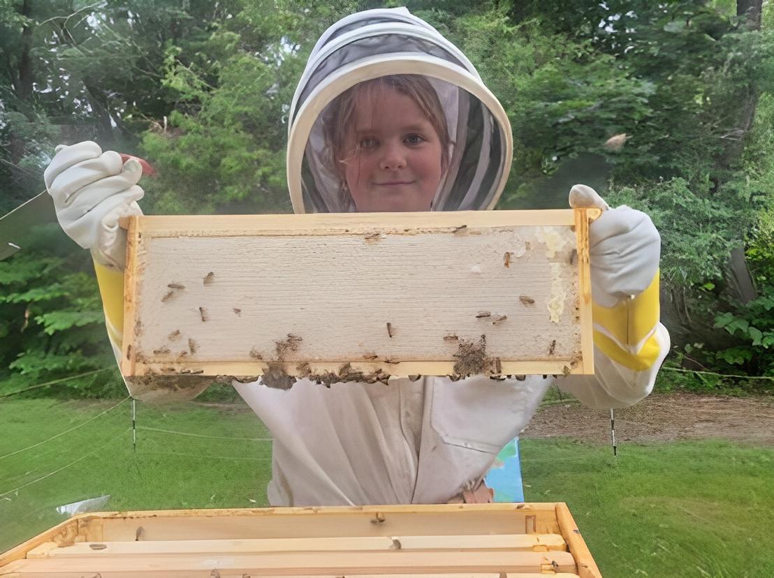  Elizabeth Downs shows off some of the bees from her hive. (Courtesy of Rachel Downs)