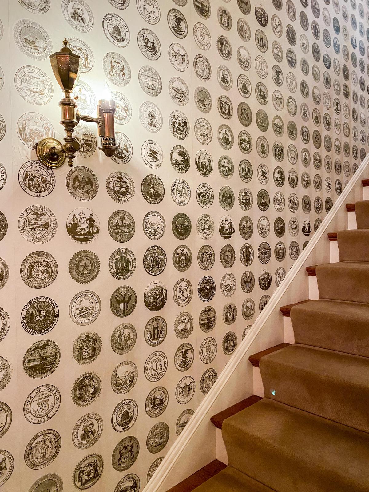Eisenhower’s entry hall greets visitors with this eye-catching specially made wallpaper<br/>showcasing state seals, as well as the nation’s seal. (Lynn Topel)