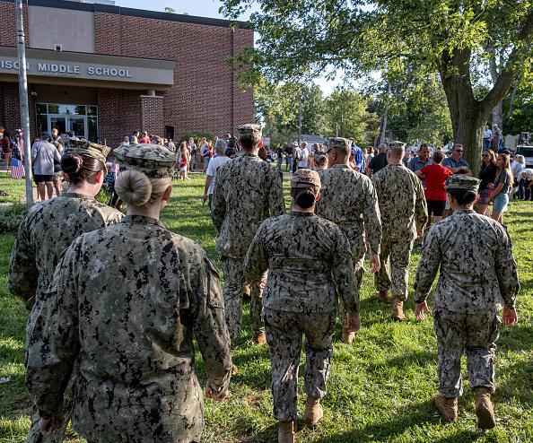  U.S. Navy service members arrive to attend a vigil for Navy Corpsman Maxton "Max" W. Soviak in Berlin Heights, Ohio, on Aug. 29, 2021. Soviak was killed during the Aug. 26 terrorist attack outside of Kabul Airport in Afghanistan along with 12 other American service members. (Seith Herald/AFP via Getty Images)