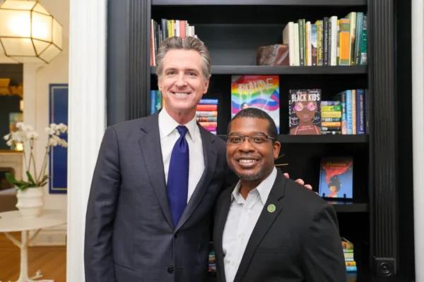  California Gov. Gavin Newsom (L) signs a state bill prohibiting local school boards from excluding textbooks and instructional materials containing "inclusive and diverse perspectives," accompanied by the bill's author Assemblyman Corey Jackson, D-Perris, in Sacramento, Calif., on Sept. 25, 2023. (Courtesy of Office of Governor Gavin Newsom)