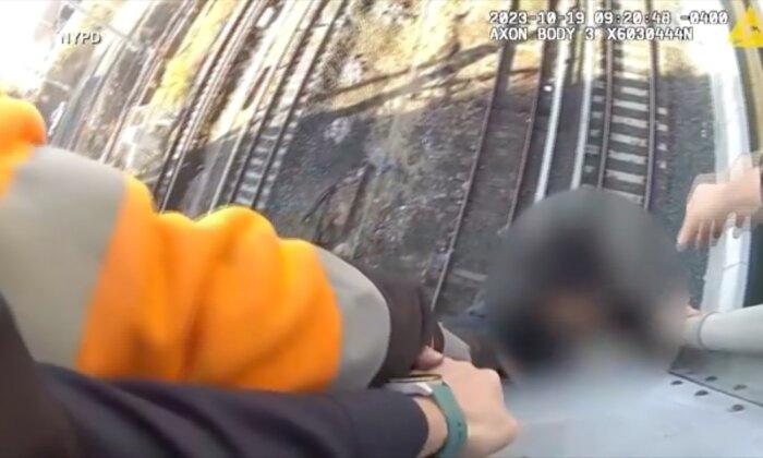 Video: Teenager Dangling Above NYC Train Tracks Rescued as Train Approaches