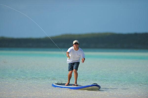 It's possible to combine two Caribbean island pleasures by fishing from a paddleboard. (Allnaturalbeth/Dreamstime)