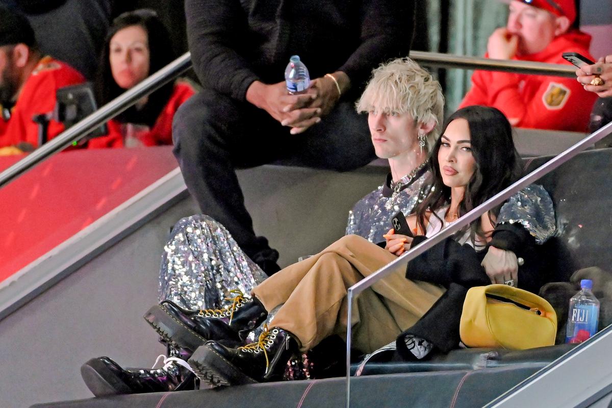  Megan Fox (R) sits with Machine Gun Kelly in Las Vegas on Feb. 5, 2022. A photo of Ms. Fox's three sons with long hair was posted on social media. (David Becker/Getty Images)