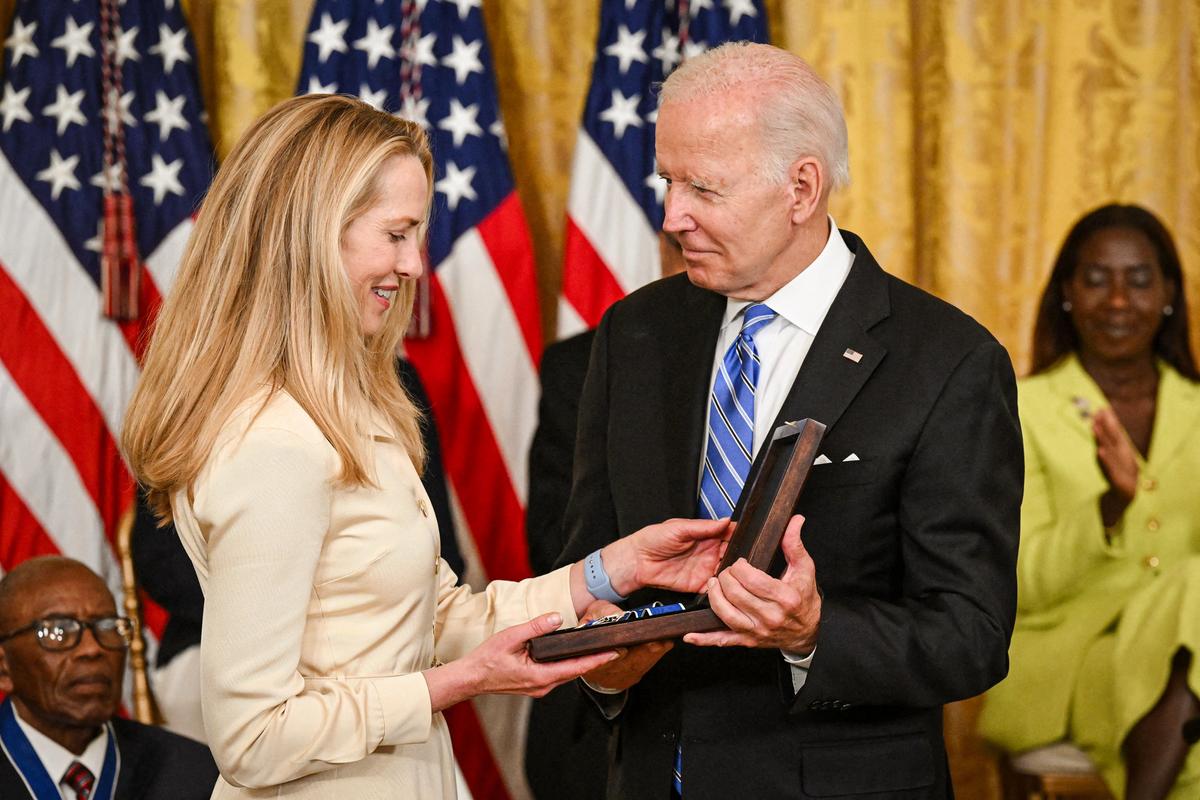 President Joe Biden presents businesswoman Laurene Powell Jobs with the Presidential Medal of Freedom for her late husband, Steve Jobs, in the White House in Washington on July 7, 2022. (Saul Loeb/AFP via Getty Images)