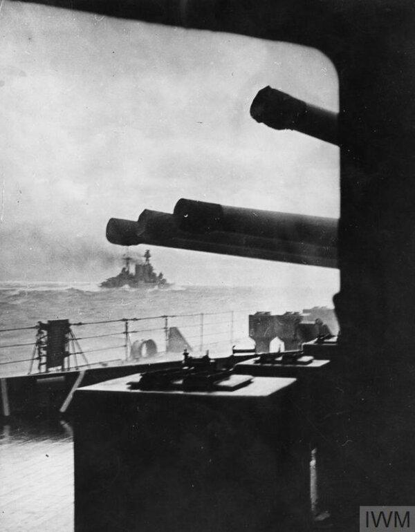The battlecruiser HMS Hood (in the distance) steaming into battle minutes before she was sunk by the German battleship Bismarck on May 24, 1941. Imperial War Museums. (Public Domain)