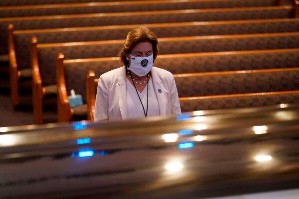 Harris County District Attorney Kim Ogg pauses by the casket of George Floyd during a funeral for Floyd, at The Fountain of Praise church in Houston, Texas, on June 9, 2020. (David J. Phillip/Pool/AFP via Getty Images)