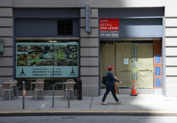 A pedestrian walks by an empty retail space in San Francisco on May 9, 2023. (Justin Sullivan/Getty Images)