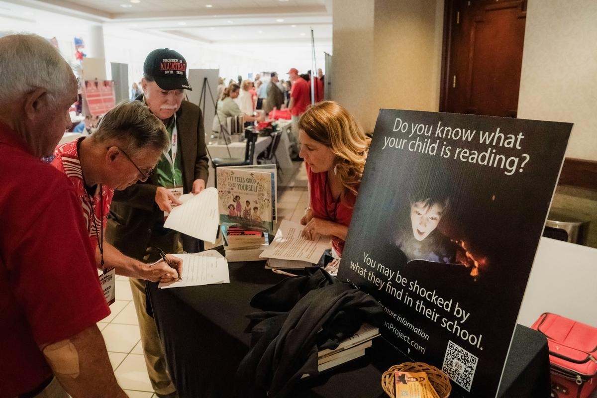 Attendees look over petitions against X-rated children's books in libraries, and against gender hormone blockers for underage children, at the North Carolina Republican Party Convention in Greensboro, N.C., on June 10, 2023. (Allison Joyce/AFP via Getty Images)