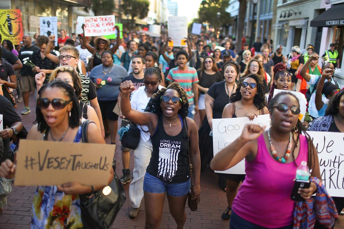 A march sponsored by the Black Lives Matter movement walks through the streets to commemorate the lives lost in the shooting at the Emanuel African Methodist Episcopal Church in Charleston, S.C., on June 20, 2015. (Photo by Joe Raedle/Getty Images)