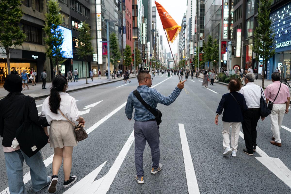 A group of Chinese tourists walks through the Ginza district during China's National Day holiday in Tokyo, on Oct. 1, 2023. (Tomohiro Ohsumi/Getty Images)
