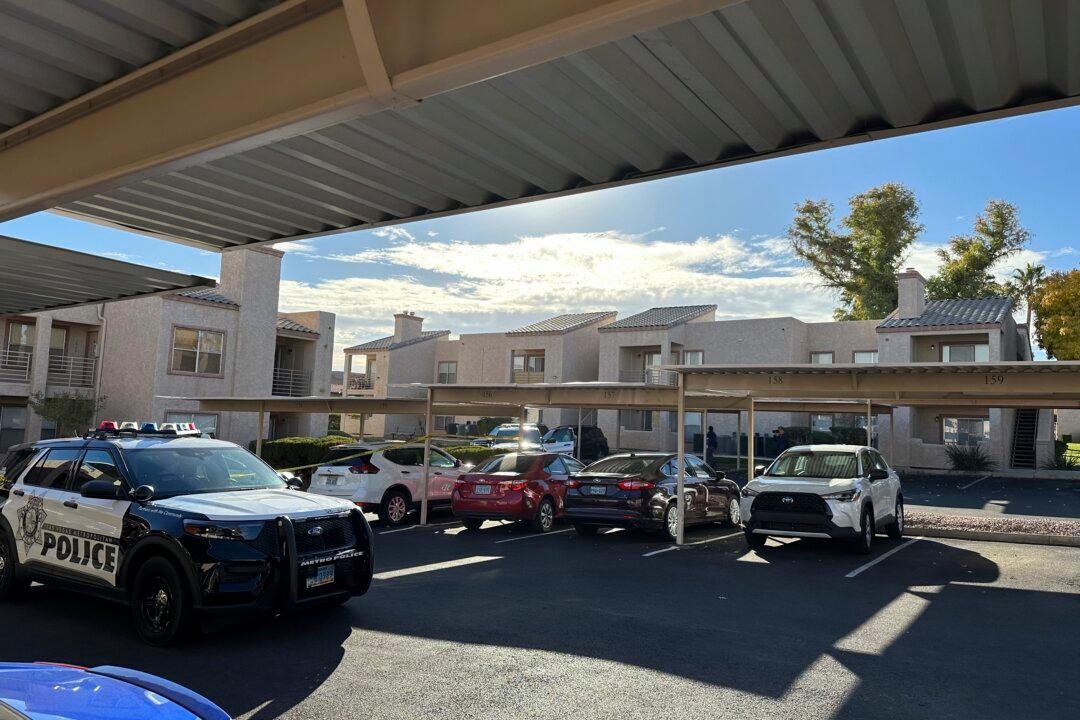 Police are stationed outside of an upstairs corner apartment in Henderson, Nev., on Dec. 7, 2023, where the suspect in a fatal shooting at the University of Nevada, Las Vegas, lived. (Ken Ritter/AP Photo)
