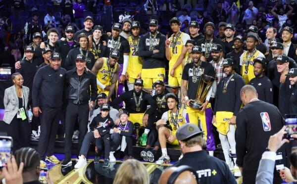 The Los Angeles Lakers pose as they celebrate their victory over the Indiana Pacers to win the championship game of the inaugural NBA In-Season Tournament in Las Vegas on Dec. 9, 2023. (Ethan Miller/Getty Images)