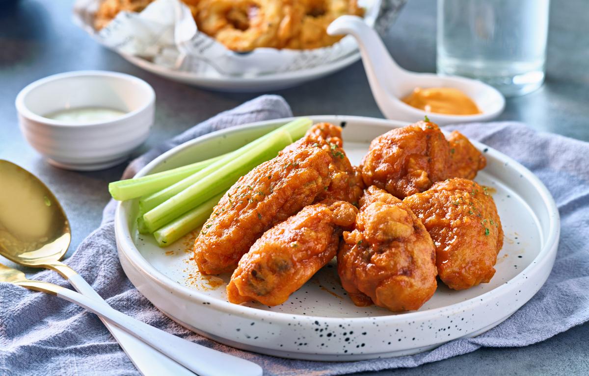Buffalo wings traditionally are tossed in a sauce made with Frank’s RedHot sauce and butter. (rez-art/iStock/Getty Images Plus)