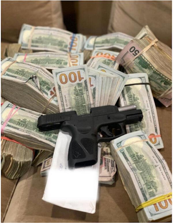 An unregistered handgun and U.S. currency seized during a police investigation of an RV in the Westlake neighborhood of Los Angeles on Jan. 31, 2024. (Courtesy of Los Angeles Police Department)