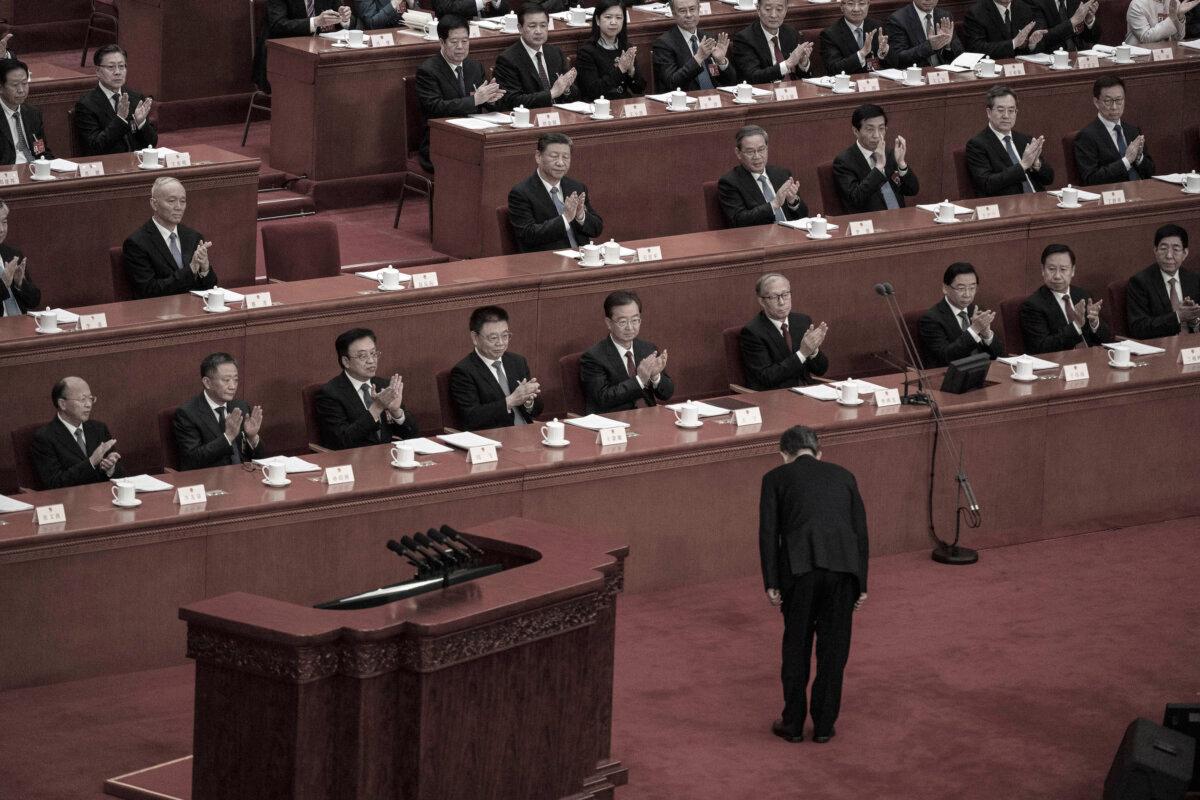 NPC Chairman Zhao Leji, bows to Chinese President Xi Jinping (C) before his speech during the second plenary session of the NPC, or National People's Congress, at the Great Hall of the People in Beijing on March 8, 2024.(Kevin Frayer/Getty Images)