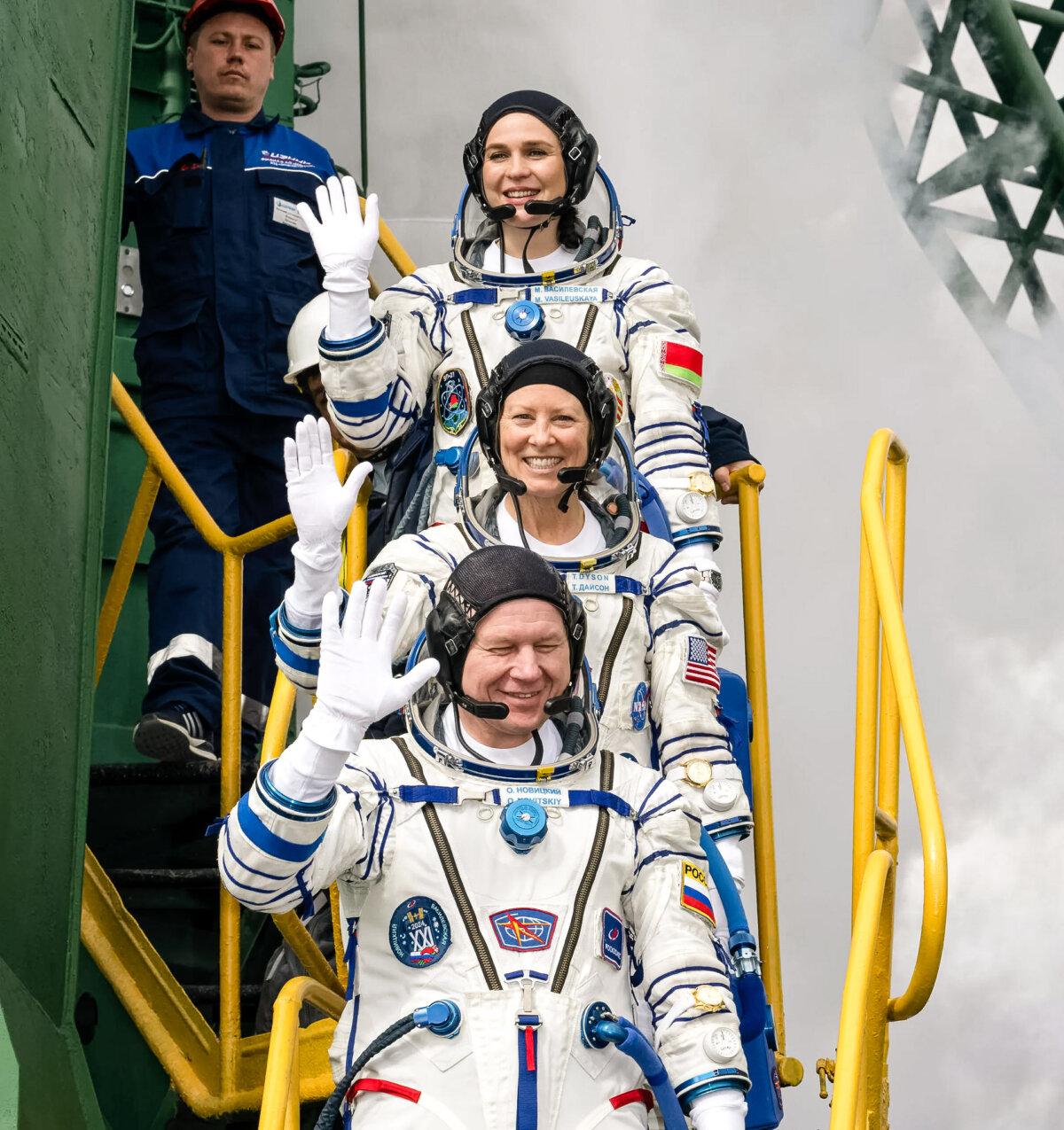 Belarus spaceflight participant Marina Vasilevskaya, top, NASA astronaut Tracy Dyson, middle, and Roscosmos cosmonaut Oleg Novitskiy before boarding the Soyuz MS-25 spacecraft for launch, at the Baikonur Cosmodrome in Kazakhstan, on March 23, 2024. (Bill Ingalls/NASA via AP)
