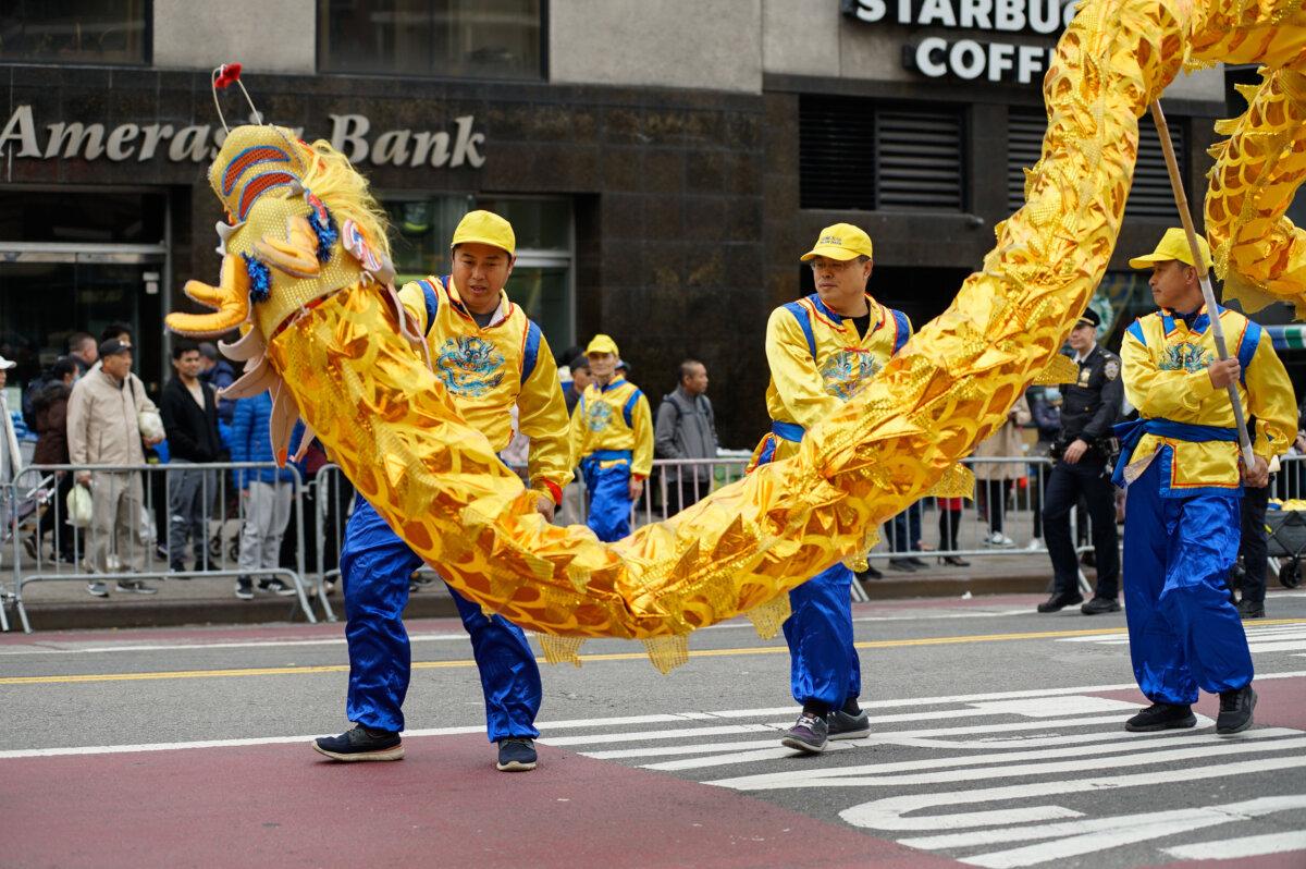 Falun Gong practitioners attend a parade to call for an end to the persecution in China of their faith, in the Flushing neighborhood of Queens, New York, on April 21, 2024. (Chung I Ho/The Epoch Times)