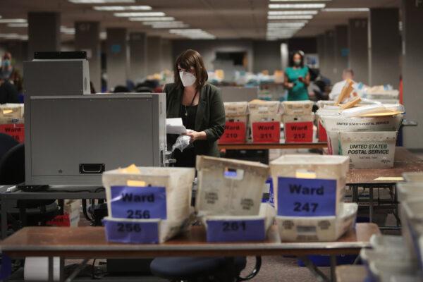 Claire Woodall-Vogg, executive director of the Milwaukee election commission, collects the count from absentee ballots from a voting machine in Milwaukee, Wisconsin, on Nov. 4, 2020. (Scott Olson/Getty Images)