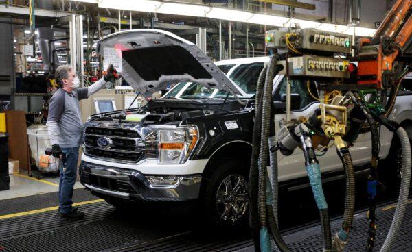 A Ford assembly worker works on an F-series pickup truck at the Dearborn Truck Plant in Dearborn, Mich., on Jan. 26, 2022. (Rebecca Cook/Reuters)
