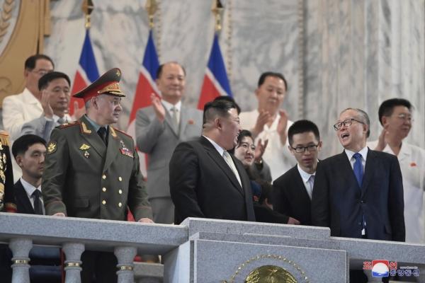In this photo provided by the North Korean regime, North Korean leader Kim Jong Un (C) talks with Chinese Communist Party Politburo member Li Hongzhong (R) as they and Russian Defense Minister Sergei Shoigu (L) attend a military parade to mark the 70th anniversary of the armistice that halted fighting in the 1950–1953 Korean War, on Kim Il Sung Square in Pyongyang, North Korea, on July 27, 2023. (Korean Central News Agency/Korea News Service via AP)