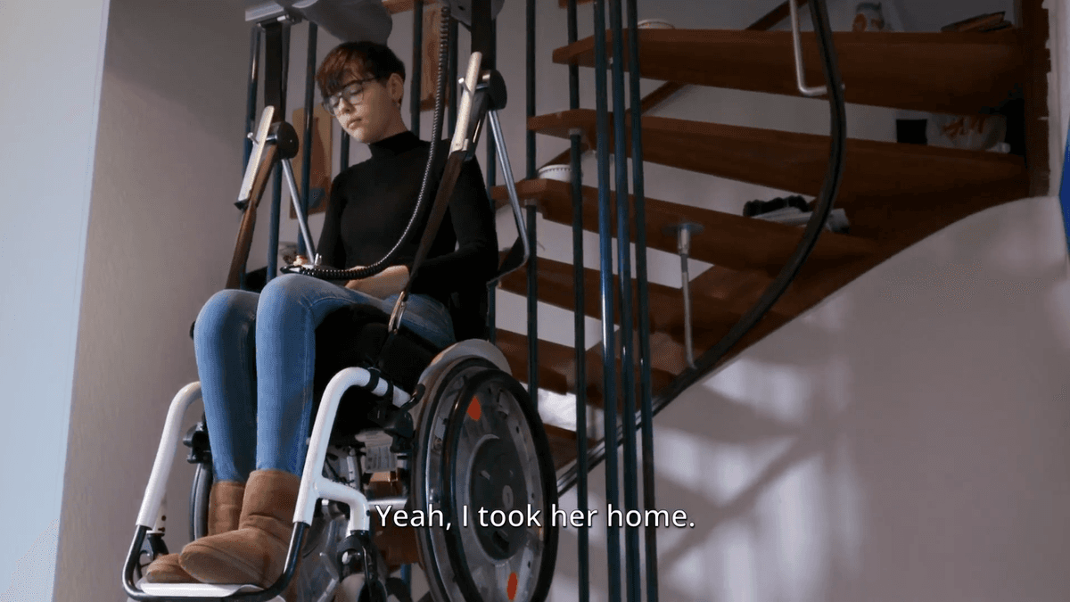 An electronic device transports Paula upstairs with her wheelchair, as reported by The Epoch Times on Sept. 23, 2022. (The Epoch Times "Under the Skin" documentary)