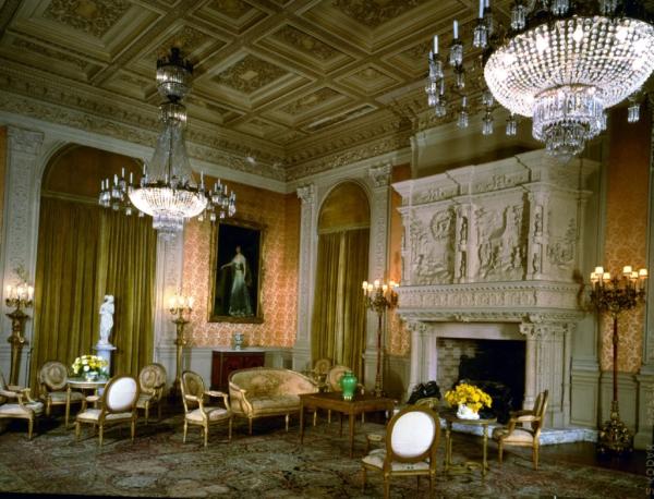 The painting of a Newport socialite, Mrs. Crawford Hill, by Hungarian artist Louis Mark graces a main wall in Rosecliff’s salon. The chimney piece, artistically created in the late Gothic/early French Renaissance style, features a scene in plaster from the legend of “The Miraculous Transport of the Casa Sagrada.” Gilded furnishings as well as gold-hued fabric wall and window treatments embellish the grand room that sits beneath a gilded, molded-plaster ceiling. (Courtesy of The Preservation Society of Newport County)